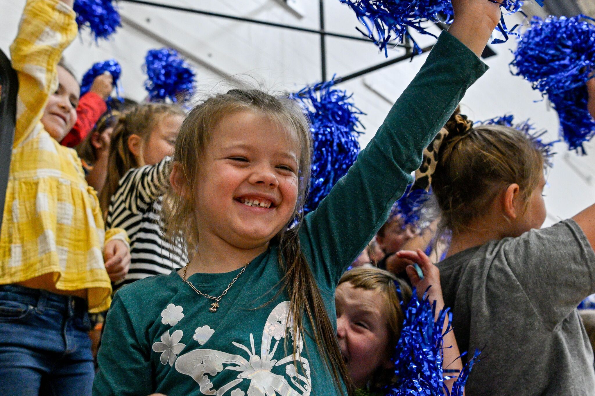 Elementary students with pom poms