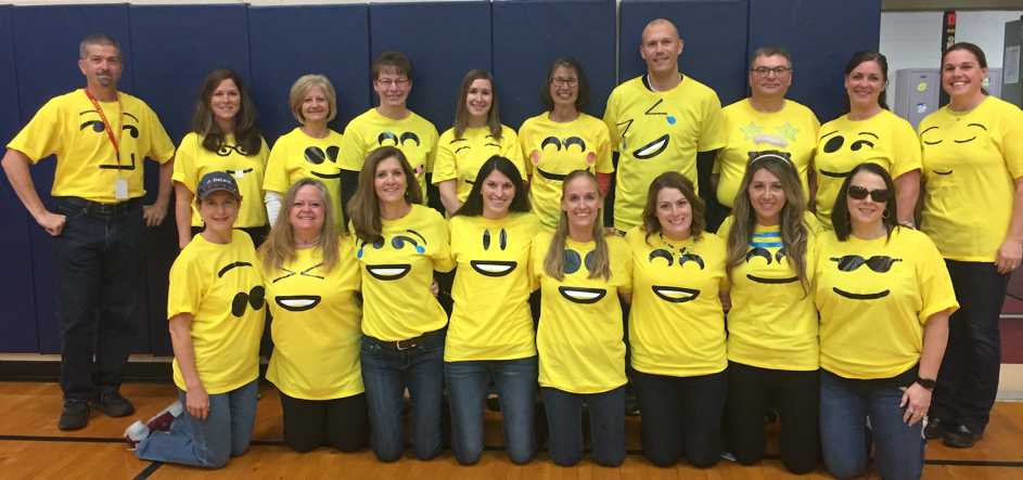 Elementary Staff photo from Halloween in their emoji shirts