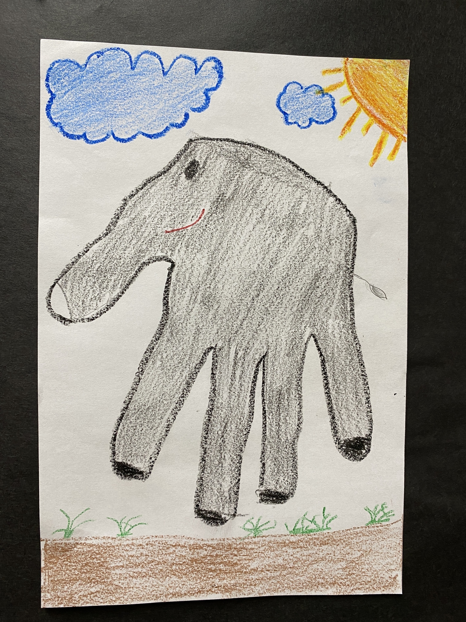Hand tracing colored with crayon to look like an elephant
