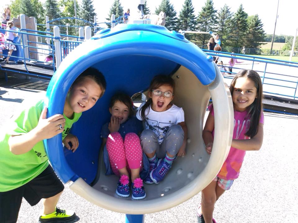 Elementary students posing on playground