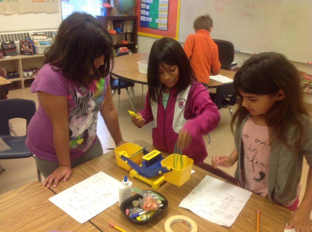 PWES students conduct a science experiment in a classroom.