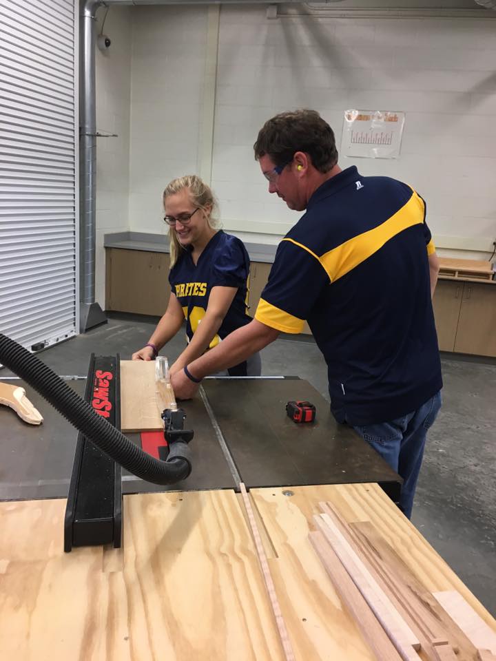 Woodshop student working with teacher
